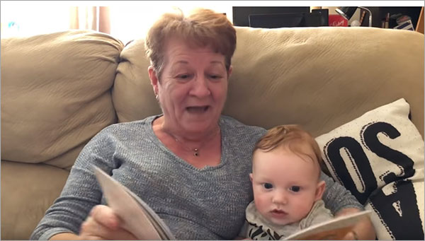 granny reading donkey story to baby